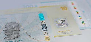 Close-up of three sample banknotes showing different security features by KURZ