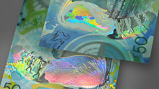 Perfect match of optical security effects and metallized design Close-up of KINEGRAM ZERO.ZERO® sample showing a butterfly and a walking man