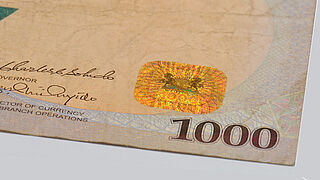 The 1000 Naira banknotes of Nigeria feature a fully metallized KINEGRAM® Patch Close-up of a fully metallized KINEGRAM® Patch on the Nigerian 1000 Naira banknote