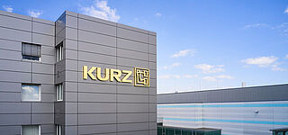 Image of KURZ headquarters building with logo attached 